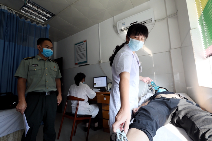 8月4日,在广西柳州市融安县人民医院征兵体检站,一名应征青年正在进行